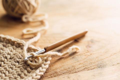 crochet work with yarn and needle